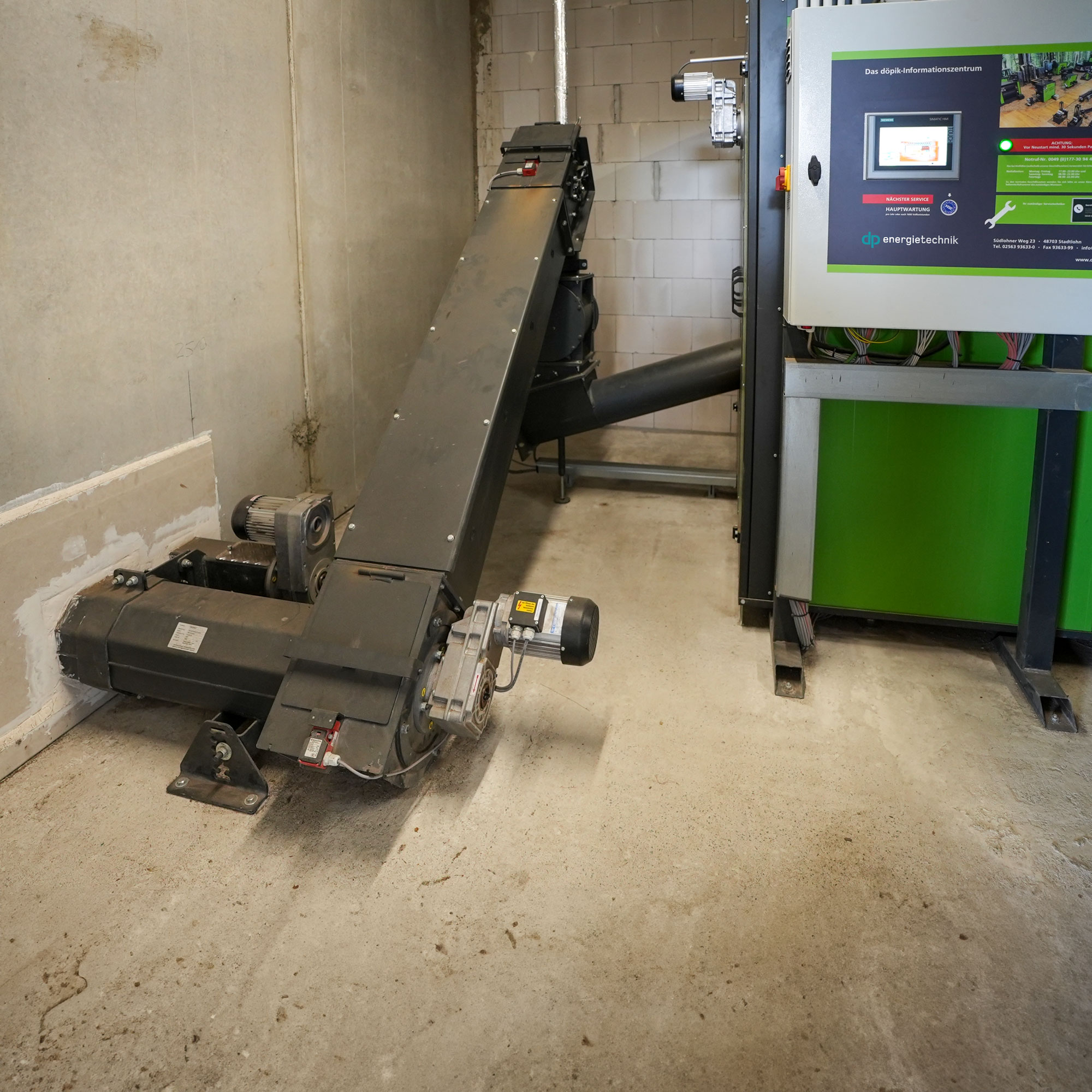 zellenradschleuse-schnecke-hackschnitzel Brennstofffördertechnik vor einer Biomasseheizung von Heizomat